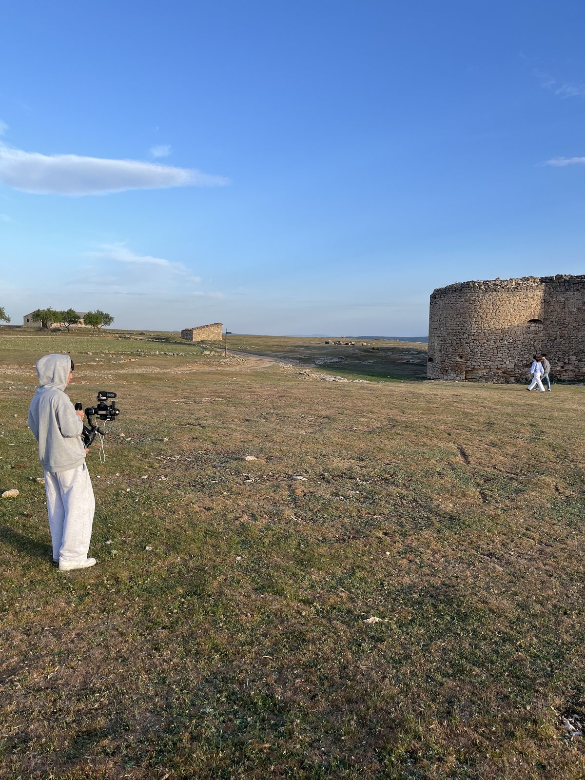 Camera operator filming outdoors on location