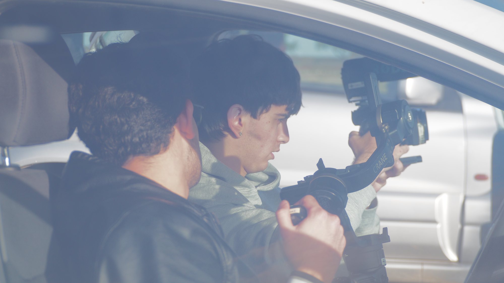 Camera operator filming inside a car
